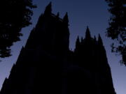 FILE - The Washington National Cathedral is seen at dawn in Washington on Friday, Nov. 5, 2021. Amid the surge of coronavirus cases across the U.S., this and many other churches have cancelled in-person Christmas services, disappointing pastors and churchgoers who consider them an annual highlight.