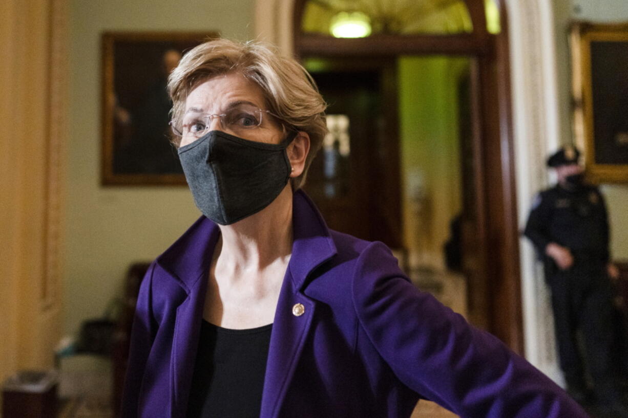 Sen. Elizabeth Warren, D-Mass., speaks to a reporter on Capitol Hill in Washington, Tuesday, Dec.