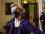 Sen. Elizabeth Warren, D-Mass., speaks to a reporter on Capitol Hill in Washington, Tuesday, Dec.