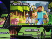 FILE - Lydia Winters shows off Microsoft's "Minecraft" built specifically for HoloLens at the Xbox E3 2015 briefing before Electronic Entertainment Expo, June 15, 2015, in Los Angeles. Security experts around the world raced Friday, Dec. 10, 2021, to patch one of the worst computer vulnerabilities discovered in years, a critical flaw in open-source code widely used across industry and government in cloud services and enterprise software. Cybersecurity experts say users of the online game Minecraft have already exploited it to breach other users by pasting a short message into in a chat box.