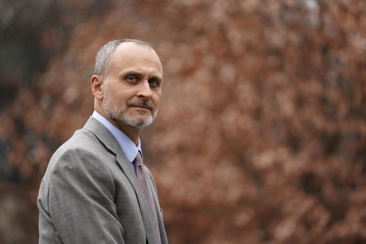 Kenneth Trzaska, President of Lewis & Clark Community College, poses for a photo on the college's campus Dec. 15, 2021, in Godfrey, Ill. The small Illinois school canceled classes for days after a ransomware attack last month that knocked critical computer systems offline.