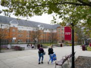 FILE - Students walk on the campus of Indiana University of Pennsylvania in Indiana, Pa., Oct. 21, 2020. The Biden administration on Wednesday, Dec. 22, 2021, extended a student loan moratorium that has allowed millions of Americans to put off debt payments during the pandemic. Under the action, payments on federal student loans will remain paused through May 1, 2022. (AP Photo/Gene J.