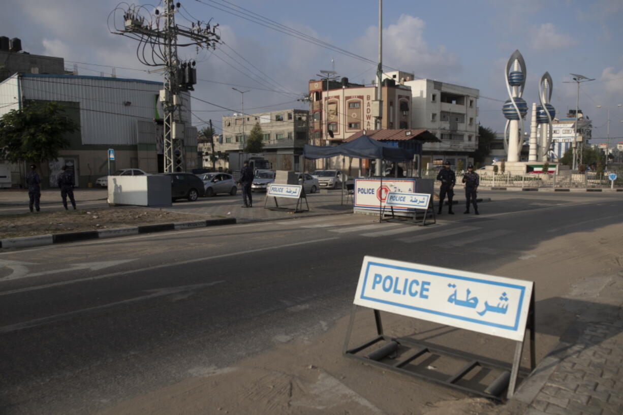 Members of Palestinian Hamas police stand guard at a checkpoint in Gaza City, Thursday, Nov. 25, 2021. Gaza's Hamas rulers collect millions of dollars a month in taxes and customs at a crossing on the Egyptian border - providing a valuable source of income that helps it sustain a government and powerful armed wing. After surviving four wars and a nearly 15-year blockade, Hamas has become more resilient and Israel has been forced to accept that its sworn enemy is here to stay.