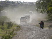 A caravan drives to the airport after departing from the Christian Aid Ministries headquarters at Titanyen, north of Port-au-Prince, Haiti, Dec. 16, 2021. Twelve remaining members of a U.S.-based missionary group who were kidnapped two months ago have been freed, according to the group and to Haitian police.