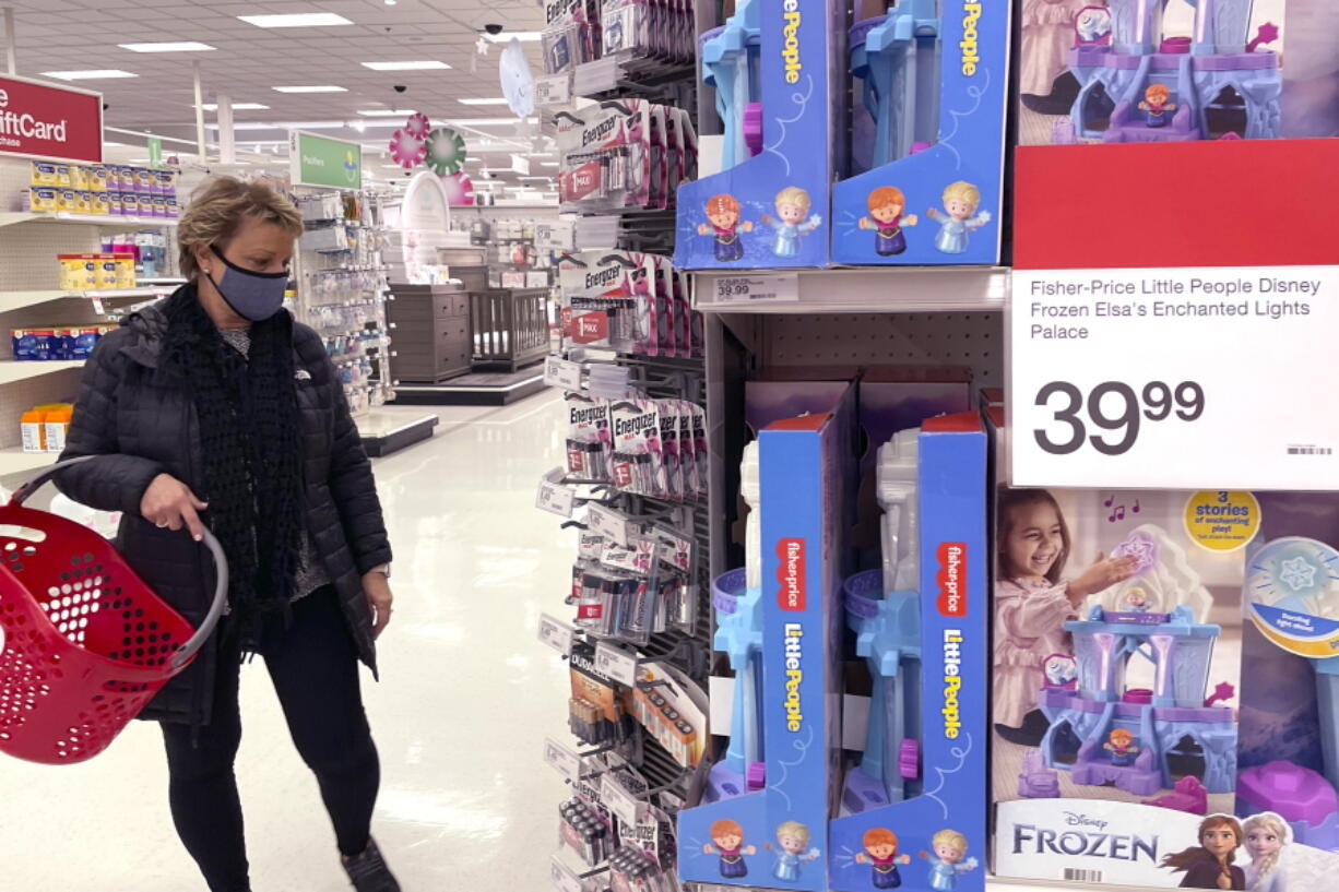 A shopper shops at a retail store in Glenview, Ill., Thursday, Dec. 16, 2021. The National Retail federation, the nation's largest retail trade group, said this month that the holiday shopping season appears to be on pace to exceed its sales growth forecast of between 8.5% and 10.5% despite additional challenges this year, from a new variant of the coronavirus, to soaring inflation. (AP Photo/Nam Y.