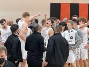 Battle Ground breaks from its post-game huddle after defeating Heritage in the Tigers' home opener Wednesday in Battle Ground.