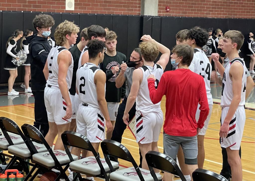 Union head coach Blake Conley, center, talks to his team during a timeout against Mount Si on Saturday at Union High School.