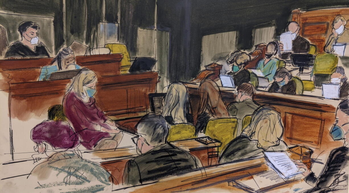 Judge Alison Nathan, upper left, reads instructions to the jury, located in the jury box on the right, during Ghislaine Maxwell's sex trafficking trial, Monday, Dec. 20, 2021, in New York. Maxwell's family, foreground, including Isabel Maxwell, right, Ian Maxwell, center and Christine Maxwell, look on.