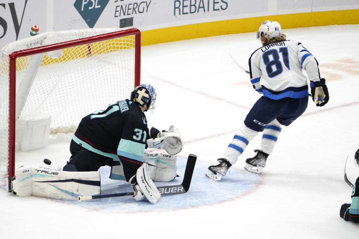 Winnipeg Jets' Kyle Connor (81) skates away after scoring on Seattle Kraken goaltender Philipp Grubauer during the third period of an NHL hockey game Thursday, Dec. 9, 2021, in Seattle. The Jets won 3-0.