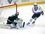 Winnipeg Jets' Kyle Connor (81) skates away after scoring on Seattle Kraken goaltender Philipp Grubauer during the third period of an NHL hockey game Thursday, Dec. 9, 2021, in Seattle. The Jets won 3-0.