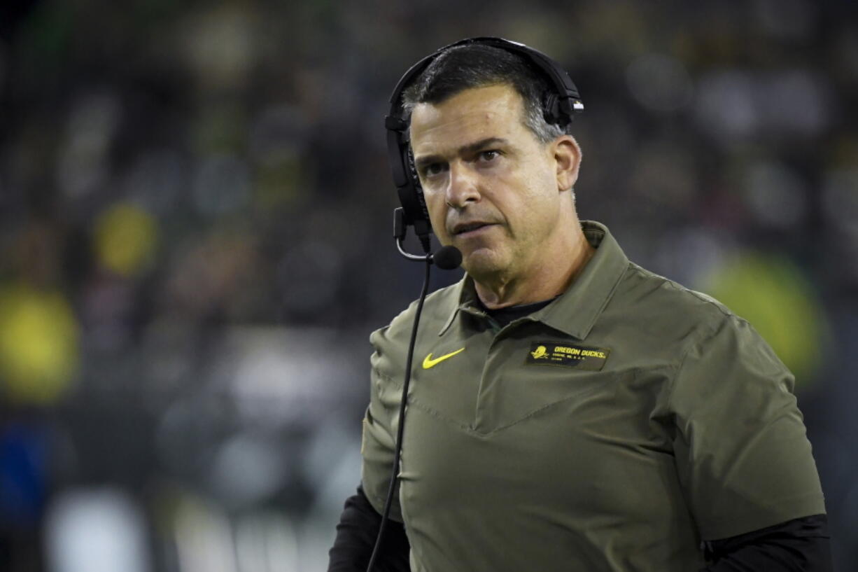 FILE -O regon head coach Mario Cristobal watches the action during the third quarter of an NCAA college football game Saturday, Nov. 13, 2021, in Eugene, Ore. Manny Diaz was fired as Miami's football coach Monday, Dec. 6, 2021, after a 7-5 regular season and with the school in deep negotiations to bring Oregon coach Mario Cristobal back to his alma mater to take over.