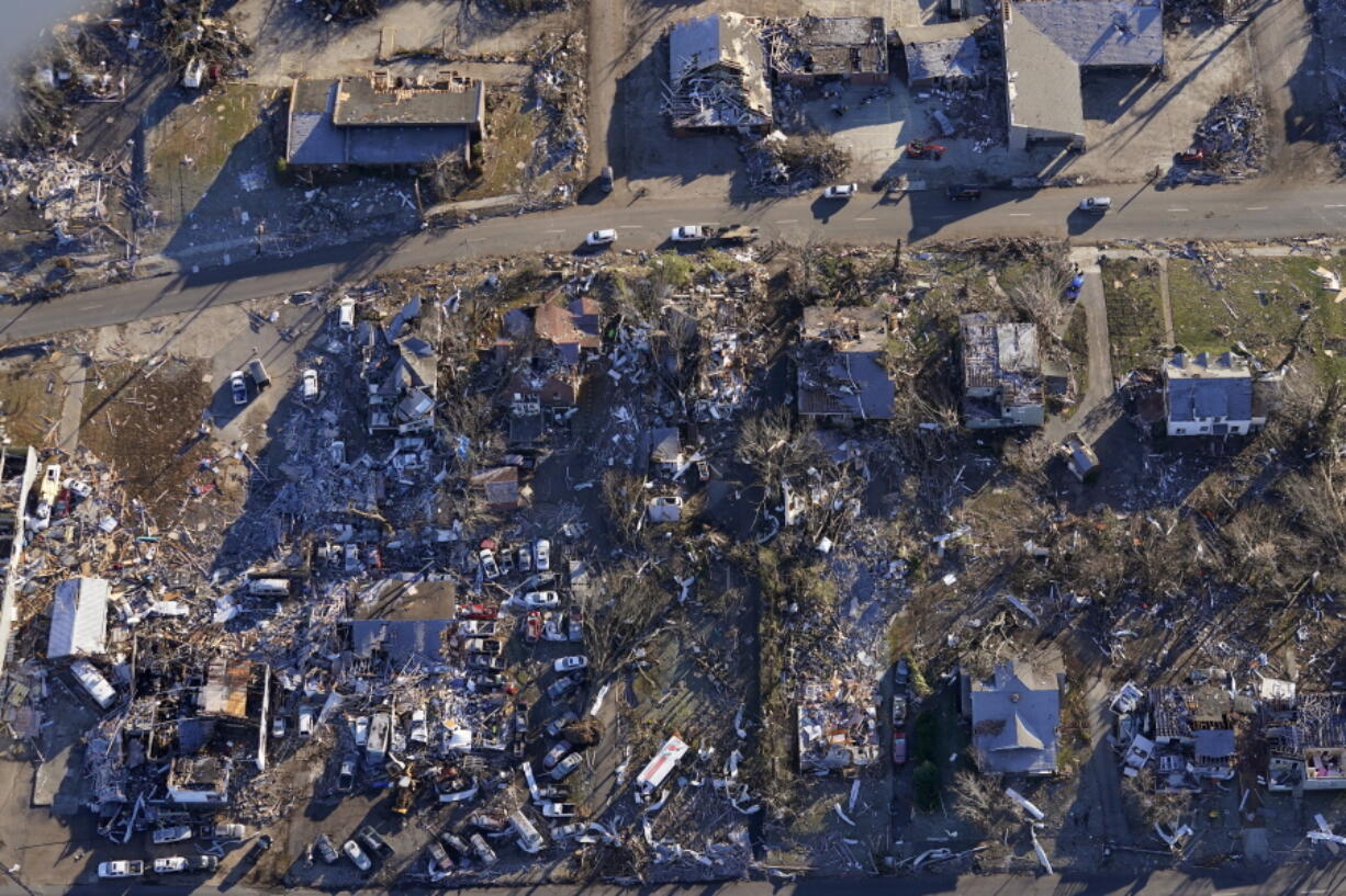 In this aerial photo, destruction from a recent tornado is seen in downtown Mayfield, Ky., Sunday, Dec. 12, 2021.