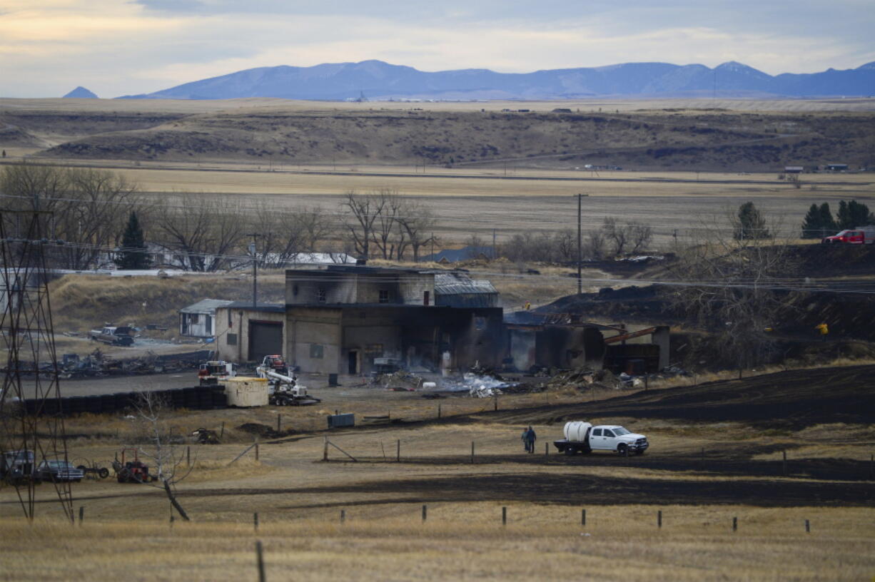 A fire burned through the Gibson Flats area south of Great Falls, Mont., on Wednesday, Dec. 1, 2021, destroying 11 homes, seven garages and 11 outbuildings, fire officials said. The fire was one of three wind-driven fires on Wednesday that forced evacuations in Montana. A fire near Denton led hundreds of residents to flee the central Montana town on Wednesday. Some buildings in the town were on fire. Another grass fire forced temporary evacuations near Browning, east of Glacier National Park.