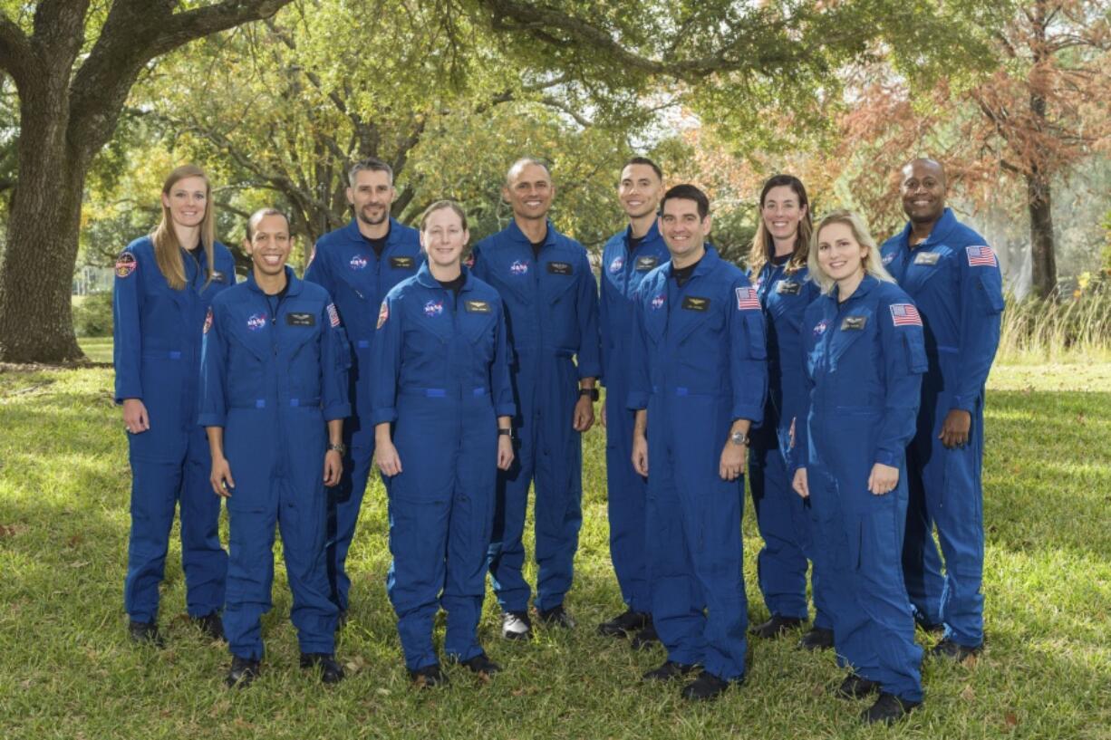 This photo provided by NASA shows its 2021 astronaut candidate class, announced on Monday, Dec. 6, 2021. The 10 candidates stand for a photo at the Johnson Space Center in Houston on Dec. 3, 2021. From left are U.S. Air Force Maj. Nichole Ayers, Christopher Williams, U.S. Marine Corps Maj. (retired.) Luke Delaney, U.S. Navy Lt. Cmdr. Jessica Wittner, U.S. Air Force Lt. Col. Anil Menon, U.S. Air Force Maj. Marcos Berr?os, U.S. Navy Cmdr. Jack Hathaway, Christina Birch, U.S. Navy Lt. Deniz Burnham, and Andre Douglas.