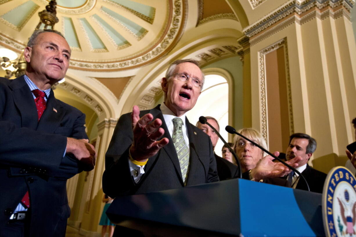 FILE - Senate Majority Leader Harry Reid, D-Nev., center, talks about the yearlong tax cut extension bill Democrats passed by a near party-line 51-48 vote, at the Capitol in Washington, on July 25, 2012. From back left are Sen. Charles Schumer, D-N.Y., Sen. Richard Durbin, D-Ill., and Sen. Patty Murray, D-Wash. Reid, the former Senate majority leader and Nevada's longest-serving member of Congress, has died. He was 82. (AP Photo/J. Scott Applewhite, File) (j.