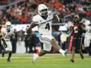 Utah State running back Calvin Tyler Jr. (4) runs to the end zone for a touchdown during the first half of the LA Bowl NCAA college football game against Oregon State in Inglewood, Calif., Saturday, Dec. 18, 2021.