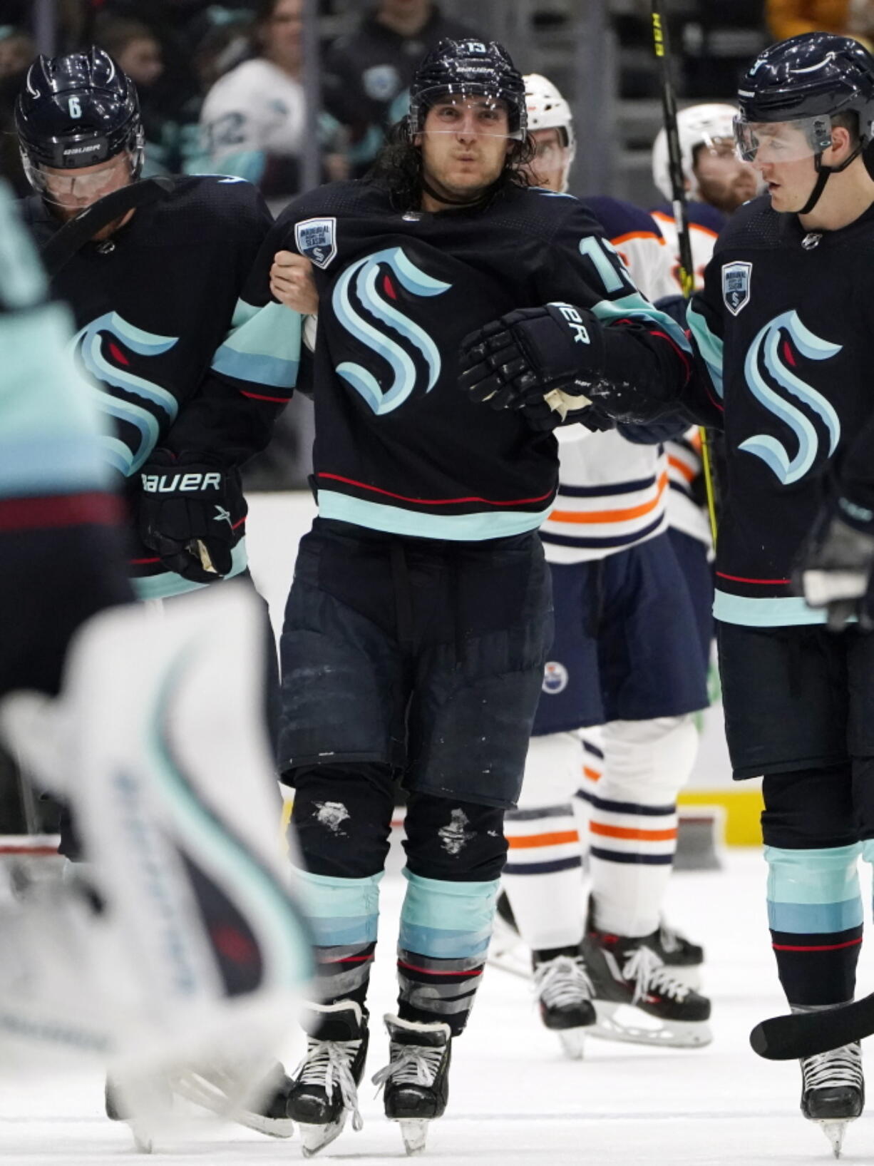 Seattle Kraken's Brandon Tanev is assisted off the ice after being injured against the Edmonton Oilers in the third period of an NHL hockey game Saturday, Dec. 18, 2021, in Seattle. The Oilers won 5-3.