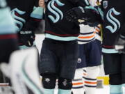 Seattle Kraken's Brandon Tanev is assisted off the ice after being injured against the Edmonton Oilers in the third period of an NHL hockey game Saturday, Dec. 18, 2021, in Seattle. The Oilers won 5-3.