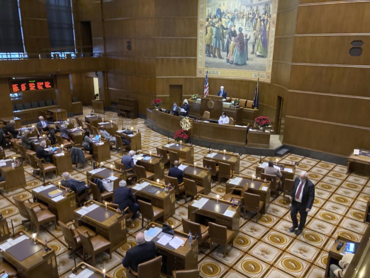 Members of the Oregon Senate meet Monday, Dec. 13, 2021, during a special session of the Oregon legislature, in Salem, Ore. As the threat of eviction looms over thousands of Oregon households, lawmakers returned to the state Capitol for a special session to take up a package of bills focused on keeping people housed during the ongoing coronavirus pandemic.