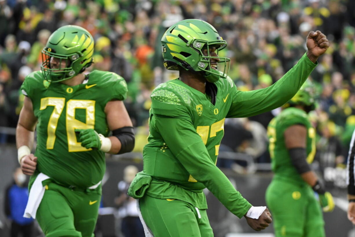 Oregon quarterback Anthony Brown (13) celebrates a touchdown against Oregon State on Saturday, Nov. 27, 2021.