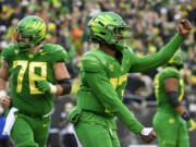 Oregon quarterback Anthony Brown (13) celebrates a touchdown against Oregon State on Saturday, Nov. 27, 2021.