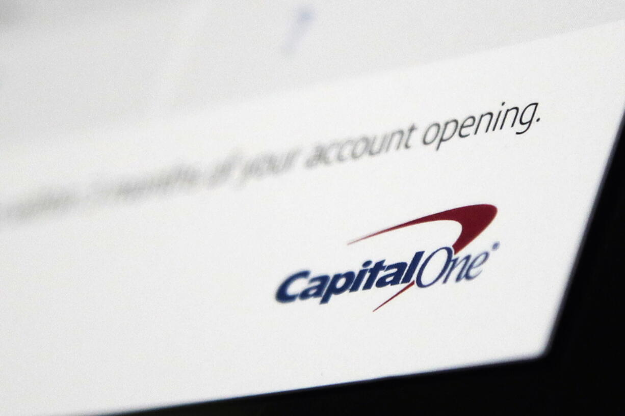 FILE - This July 22, 2019, file photo, shows a Capital One mailing in North Andover, Mass. After decades of raking in billions of dollars from mostly poor Americans short of cash in their accounts, the biggest banks, under pressure from lawmakers and regulators, are slowly decreasing their reliance on the widely unpopular practice. Capital One, the nation's sixth-largest bank, has announced that it will end all overdraft fees in 2022. Other banks have made it harder for customers to trigger an overdraft fee.