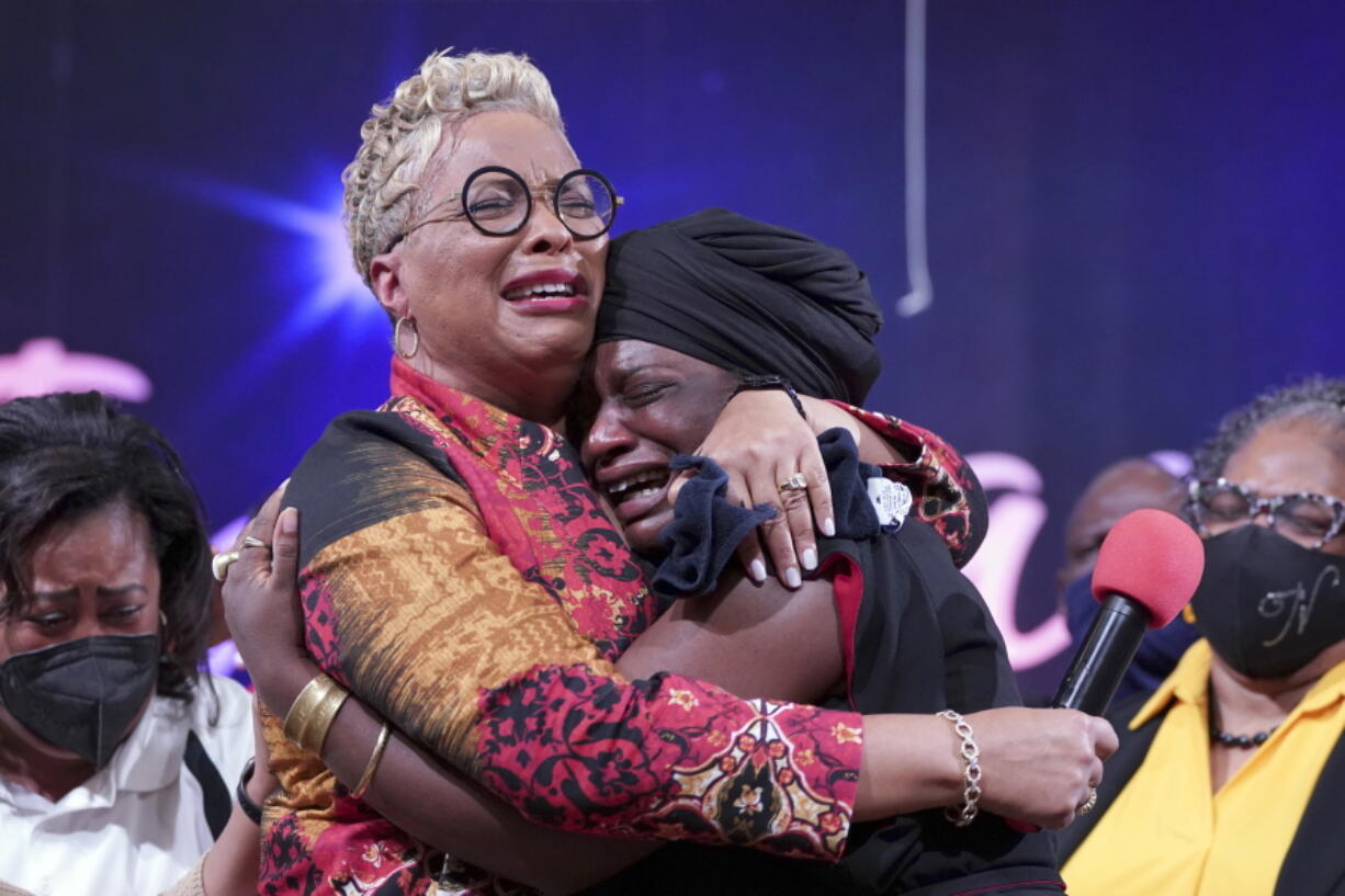 The Rev. Gina Stewart, left, senior pastor of Christ Missionary Baptist Church, comforts Hatshepsut Bandele during a church service Dec. 5 in Memphis, Tenn.