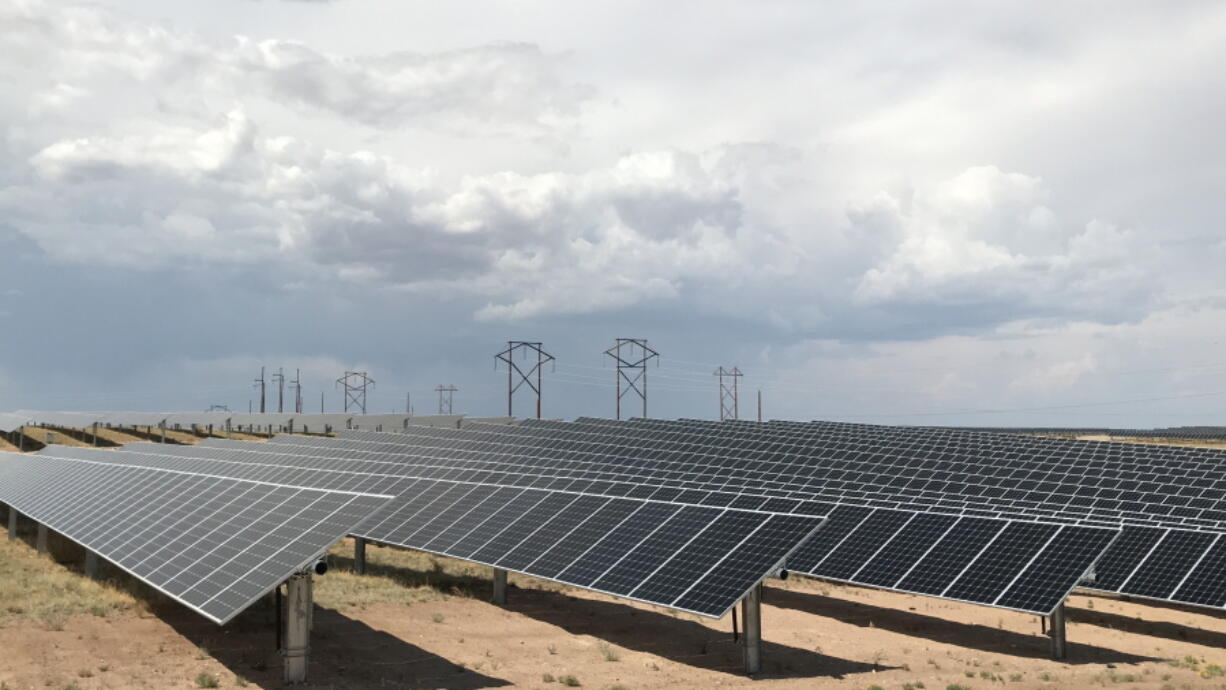 FILE - This June 15, 2021 photo shows a solar farm west of Rio Rancho, N.M., that Public Service Co. of New Mexico uses to help power Facebook's data center in central New Mexico. More than a dozen New Mexico lawmakers are petitioning state regulators to study the potential costs and benefits of publicly-owned electrical power for the state. The petition was made public Tuesday, Dec. 22, 2021.