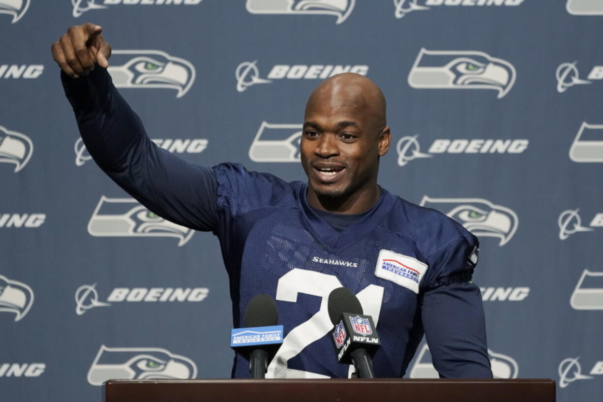 Adrian Peterson, who was signed to the Seattle Seahawks practice squad on Wednesday, talks to reporters Thursday, Dec. 2, 2021, before NFL football practice in Renton, Wash. (AP Photo/Ted S.