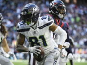 Seattle Seahawks tight end Gerald Everett (81) celebrates after scoring a touchdown against the Houston Texans during the second half of an NFL football game, Sunday, Dec. 12, 2021, in Houston.