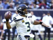 Seattle Seahawks quarterback Russell Wilson (3) throws against the Houston Texans during the first half of an NFL football game, Sunday, Dec. 12, 2021, in Houston.