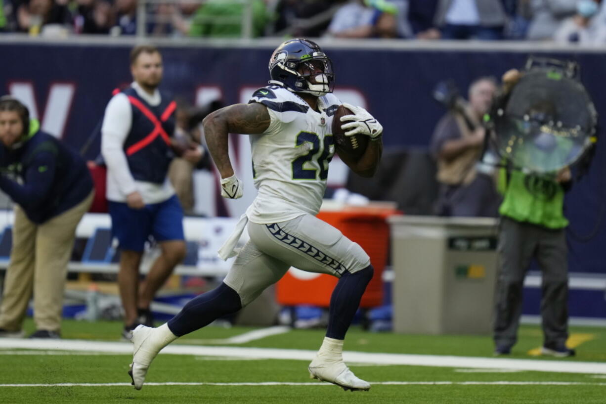 Seattle Seahawks running back Rashaad Penny (20) runs for a touchdown against the Houston Texans during the second half of an NFL football game, Sunday, Dec. 12, 2021, in Houston.