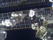 This photo provided by NASA shows astronaut Tom Marshburn replaces a broken antenna outside the International Space Station after getting NASA's all-clear for orbiting debris, on Thursday, Dec. 2, 2021.  Marshburn and Kayla Barron completed the job Thursday.