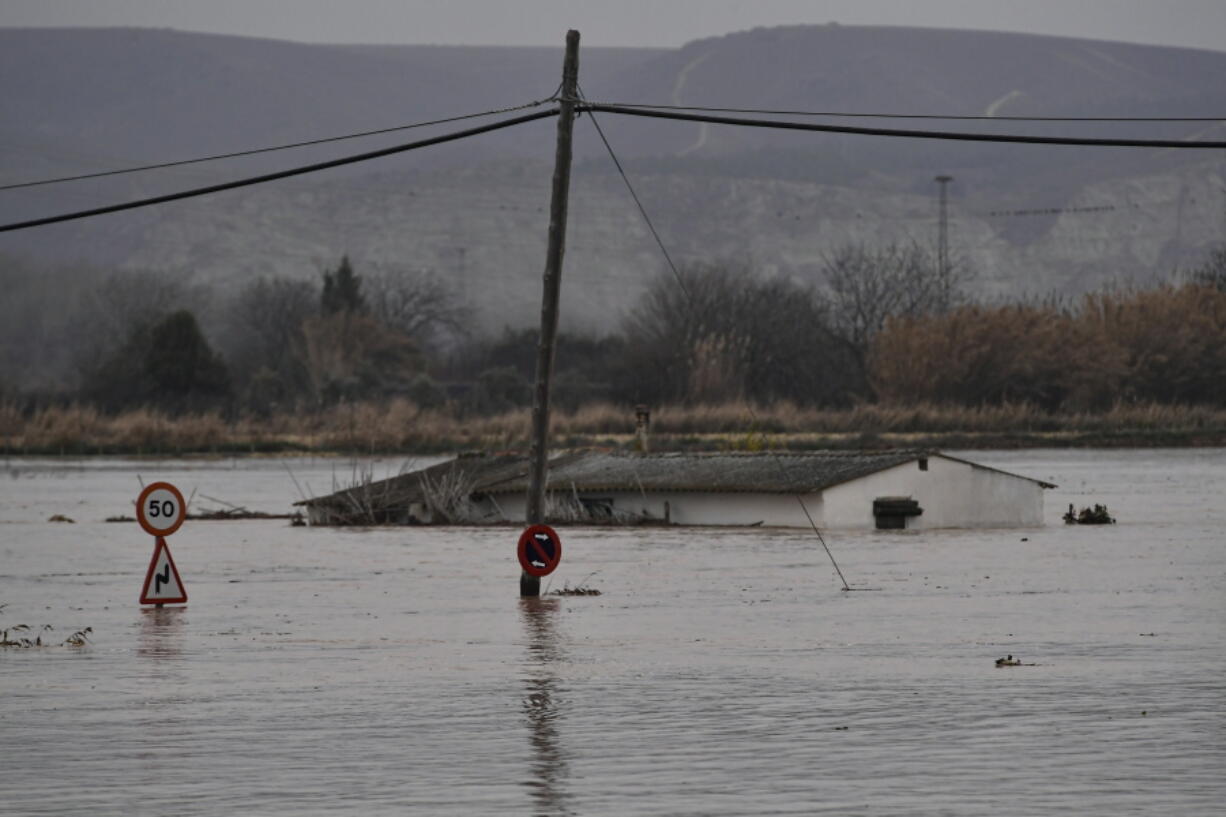 A flooded area near the Ebro River in Alfocena, near to Zaragoza Aragon province, northern Spain, Tuesday, Dec. 14, 2021. Heavy rain has led to flooding in northern Spain.