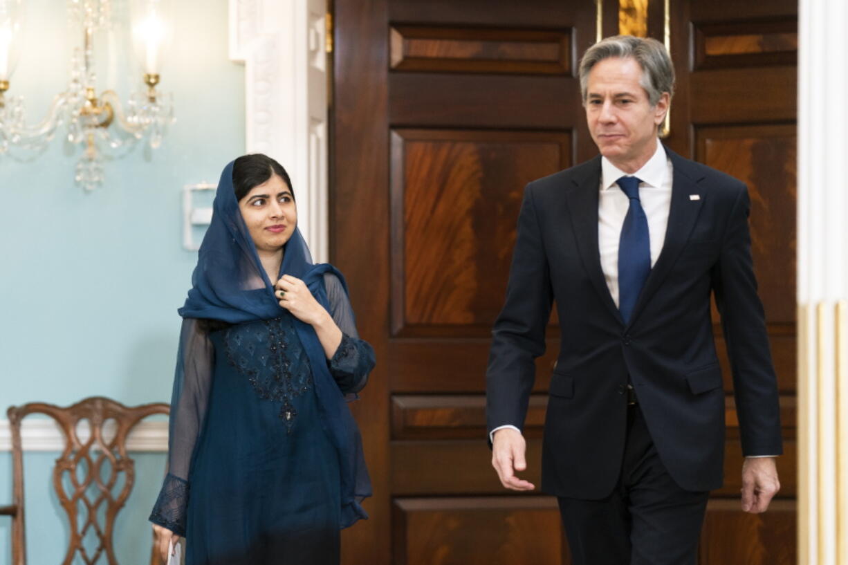 Secretary of State Antony Blinken and Pakistani activist for female education and a Nobel Peace Prize laureate Malala Yousafzai, walk to the Treaty Room at the State Department, Monday, Dec. 6, 2021, in Washington.