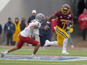 Central Michigan running back Lew Nichols (7) tries to evade Washington State defensive back Derrick Langford Jr. (5) during the first half of the Sun Bowl NCAA college football game in El Paso, Texas, Friday, Dec. 31, 2021.