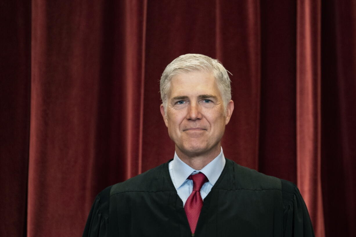 FILE - Associate Justice Neil Gorsuch stands during a group photo at the Supreme Court in Washington, April 23, 2021.