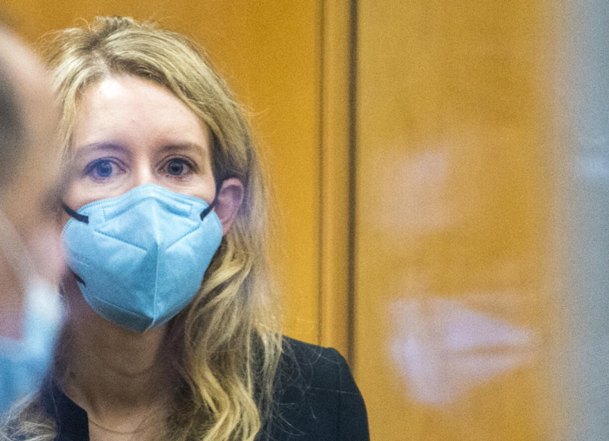 Elizabeth Holmes walks into federal court in San Jose, Calif., Thursday, Dec. 16, 2021. The lawyers for the opposing sides in the trial of former Theranos CEO are expected to wrap up their closing arguments Friday, paving the way for a jury to begin their deliberations over criminal charges accusing her of turning her blood-testing startup into a massive scam.