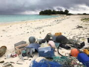 FILE - In this Oct. 22, 2019, photo, plastic and other debris is seen on the beach on Midway Atoll in the Northwestern Hawaiian Islands. America needs to rethink and reduce the way it generates plastics because so much of it is littering the oceans, the National Academy of Sciences recommends in a new report, Wednesday, Dec. 1, 2021.