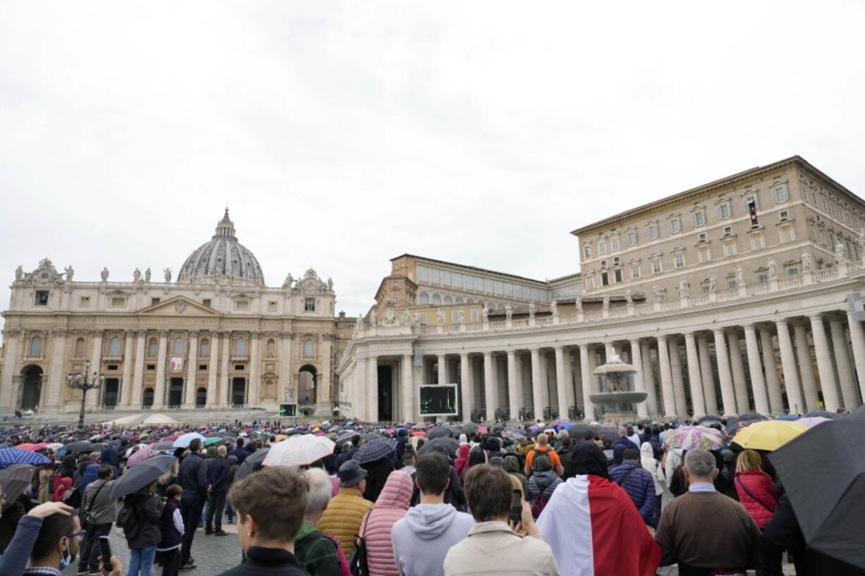 FILE - Faithful gather to listen to Pope Francis' Angelus noon prayer in St. Peter's Square, at the Vatican, Sunday, Nov. 14, 2021. The Vatican's big fraud and embezzlement trial, which opened to great fanfare in July, suffered another delay Tuesday, Dec. 14, 2021 as the tribunal postponed any further decisions until prosecutors finish redoing their investigation for four of the original 10 defendants.