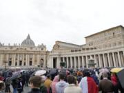 FILE - Faithful gather to listen to Pope Francis' Angelus noon prayer in St. Peter's Square, at the Vatican, Sunday, Nov. 14, 2021. The Vatican's big fraud and embezzlement trial, which opened to great fanfare in July, suffered another delay Tuesday, Dec. 14, 2021 as the tribunal postponed any further decisions until prosecutors finish redoing their investigation for four of the original 10 defendants.