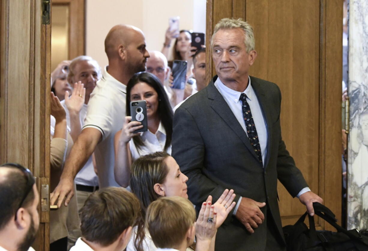 FILE - Robert F. Kennedy, Jr. arrives for a hearing about whether stricter vaccine requirements were constitutional at the Albany County Courthouse Wednesday, Aug. 14, 2019, in Albany, N.Y. Kennedy has been a key part of the anti-vaccine movement for years, but doctors and public health advocates told the AP that COVID-19 launched him to a new level.