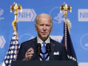 FILE - President Joe Biden speaks about the COVID-19 variant named omicron during a visit to the National Institutes of Health on Dec. 2, 2021, in Bethesda, Md. Biden plans to stress in a Dec. 21 speech the importance of getting vaccinated to protect from a wave of COVID-19 infections tied to the new omicron variant as Christmas approaches.