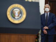 Dr. Anthony Fauci, director of the National Institute of Allergy listens as President Joe Biden speaks about the COVID-19 variant named omicron, in the Roosevelt Room of the White House, Monday, Nov. 29, 2021, in Washington.