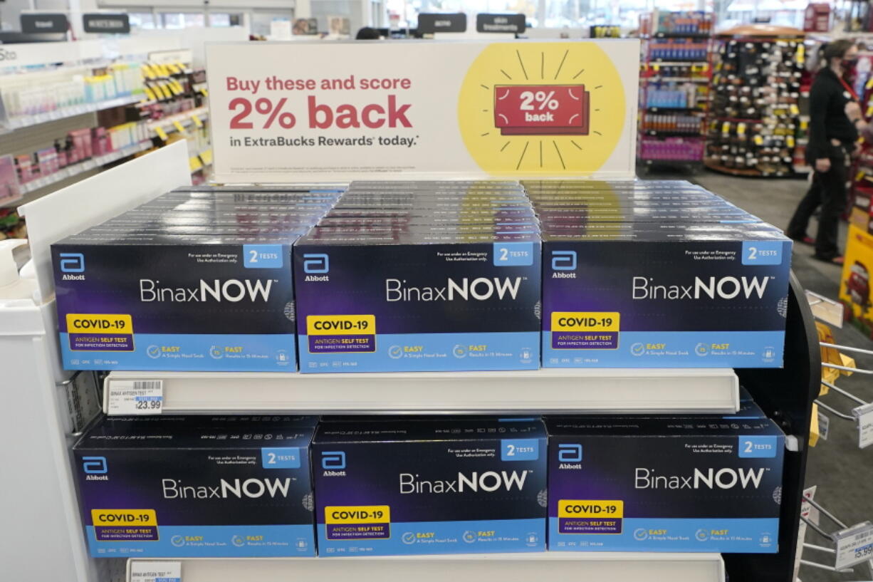 FILE - Boxes of BinaxNow home COVID-19 tests made by Abbott are shown for sale on Nov. 15, 2021, at a CVS store in Lakewood, Wash. The Biden administration's plan for health insurers to reimburse consumers for over-the-counter COVID-19 tests is recalling the model of a bygone era when the companies processed large volumes of claims from individuals -- with paper receipts. (AP Photo/Ted S.