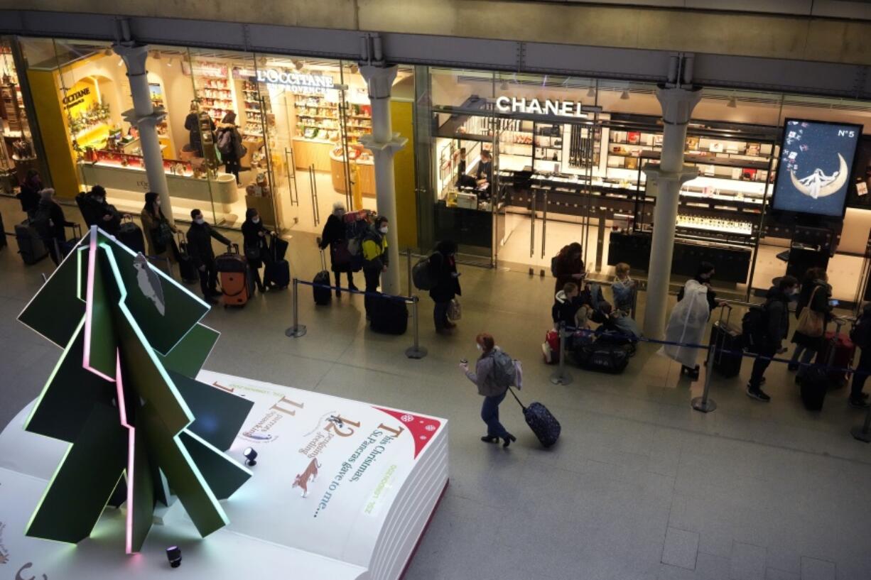 People queue up to travel on trains at London St Pancras International rail station, in London, the Eurostar hub to travel to European countries including France, Friday, Dec. 17, 2021. After the U.K. recorded its highest number of confirmed new COVID-19 infections since the pandemic began, France announced Thursday that it would tighten entry rules for those coming from Britain. Hours later, the country set another record, with a further 88,376 confirmed COVID-19 cases reported Thursday, almost 10,000 more than the day before.