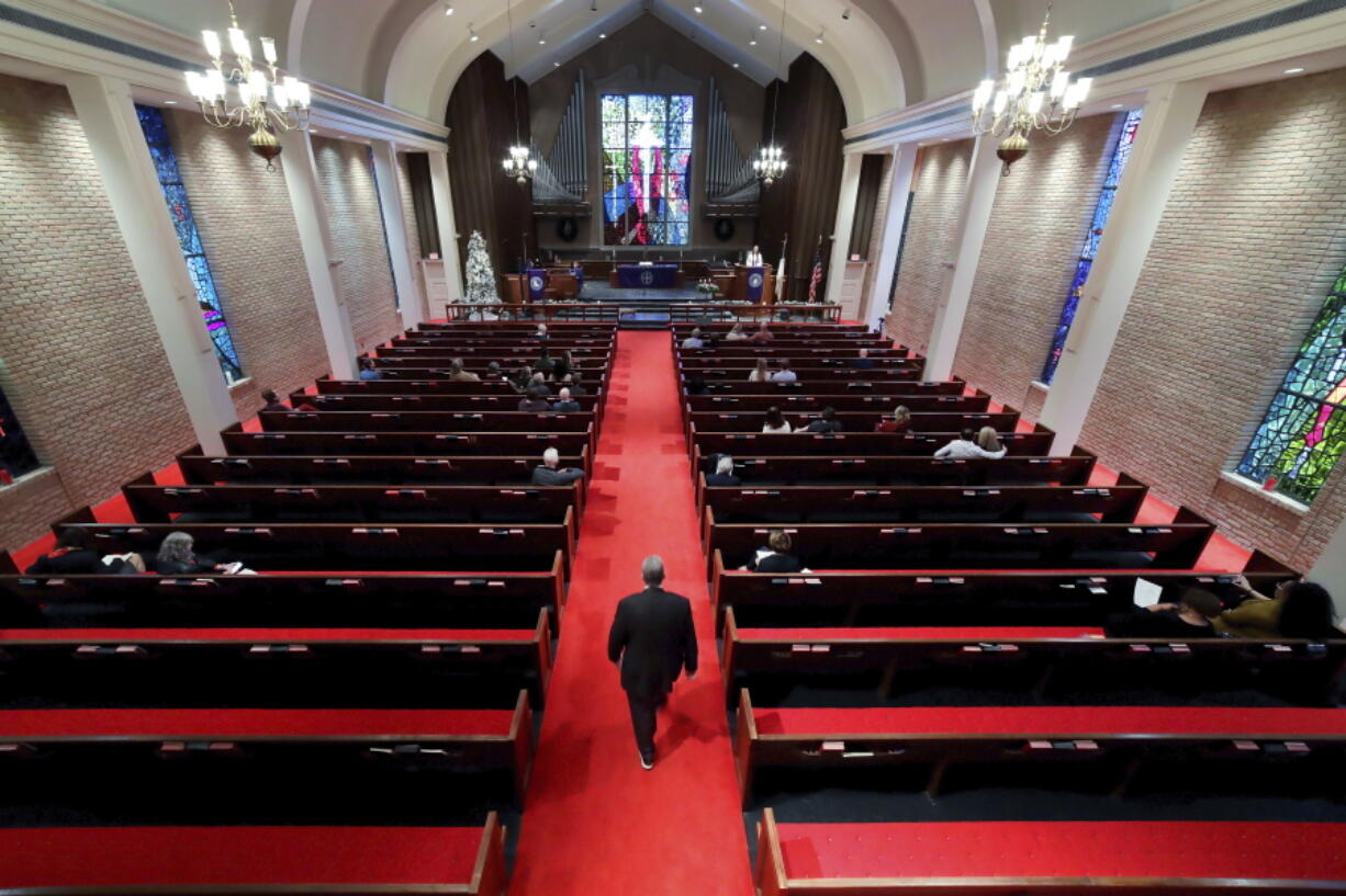 Rev. Meredith Mills delivers a sermon from the pulpit for some 30 attendants Dec. 12 during the second service of the day in the sanctuary at Westminster United Methodist Church in Houston.