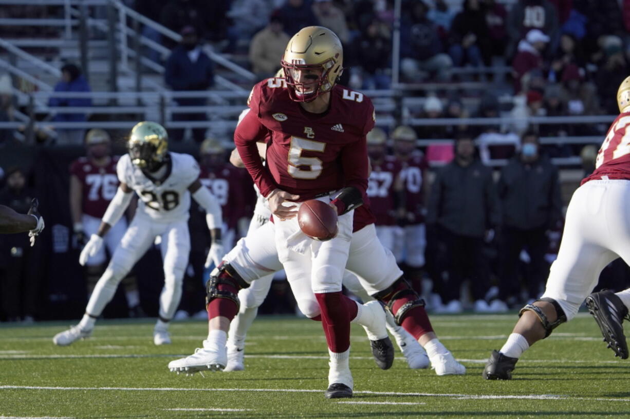 FILE - Boston College quarterback Phil Jurkovec (5) prepares to hand the ball off during the second half of an NCAA college football game against Wake Forest, Saturday, Nov. 27, 2021, in Boston. The Fenway Bowl and Military Bowl have been canceled due to the pandemic as coronavirus outbreaks at Virginia and Boston College forced them to call off their postseason plans.  The Military Bowl scheduled for Monday, Dec.