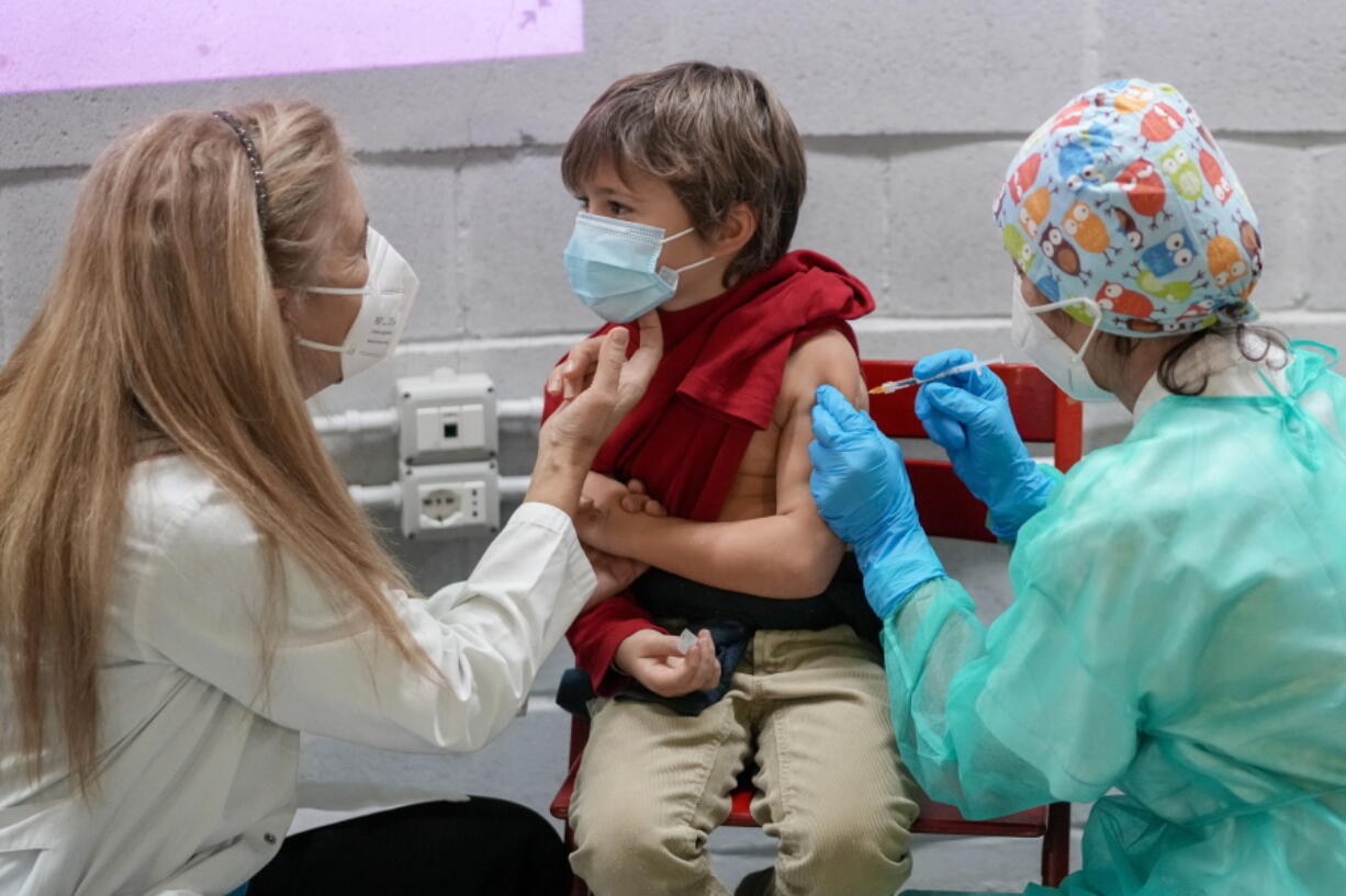 A boy receives a dose of Pfizer-BioNTech COVID-19 vaccination for children aged 5 - 11, in Rome, Wednesday, Dec. 15, 2021. Italy has started vaccinating children aged 5-11 against COVID-19 as the government braces for the spread of the omicron variant during the holiday season.