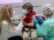 A boy receives a dose of Pfizer-BioNTech COVID-19 vaccination for children aged 5 - 11, in Rome, Wednesday, Dec. 15, 2021. Italy has started vaccinating children aged 5-11 against COVID-19 as the government braces for the spread of the omicron variant during the holiday season.